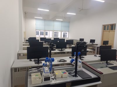 Six-axis robotic arm sorting objects in a low-cost robotics training lab