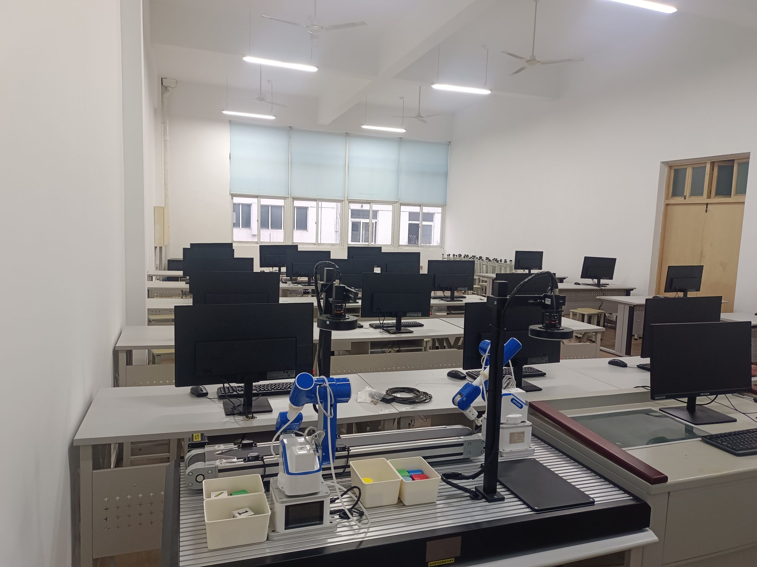 Six-axis robotic arm sorting objects in a low-cost robotics training lab